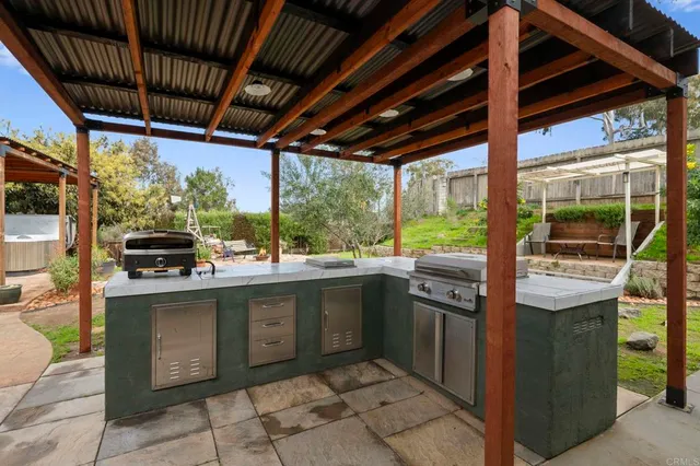 a kitchen with stainless steel appliances granite countertop a sink and a counter
