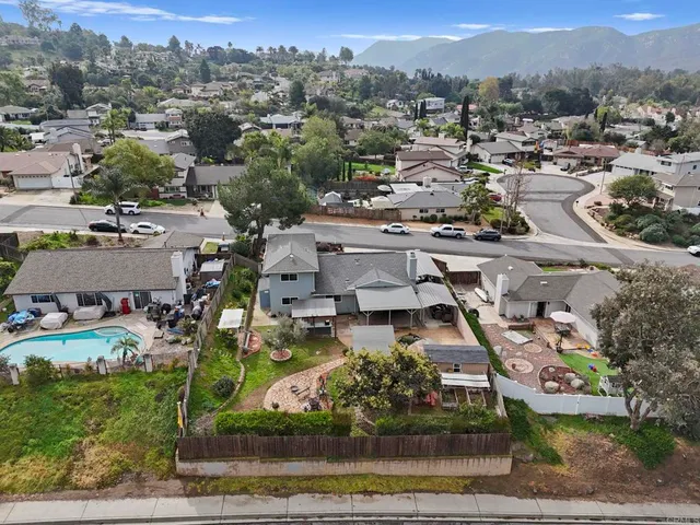 an aerial view of a residential houses with outdoor space and street view