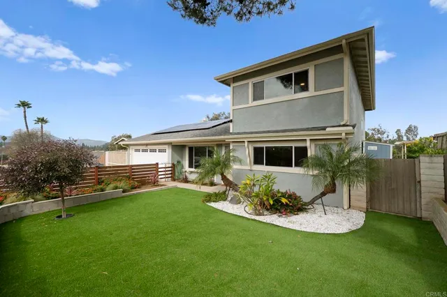 a front view of a house with a yard table and chairs