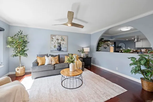 a living room with furniture potted plant and a chandelier