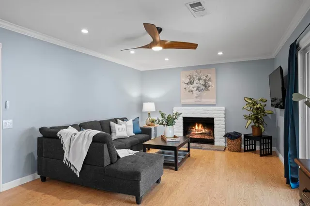 a living room with furniture fireplace and potted plant