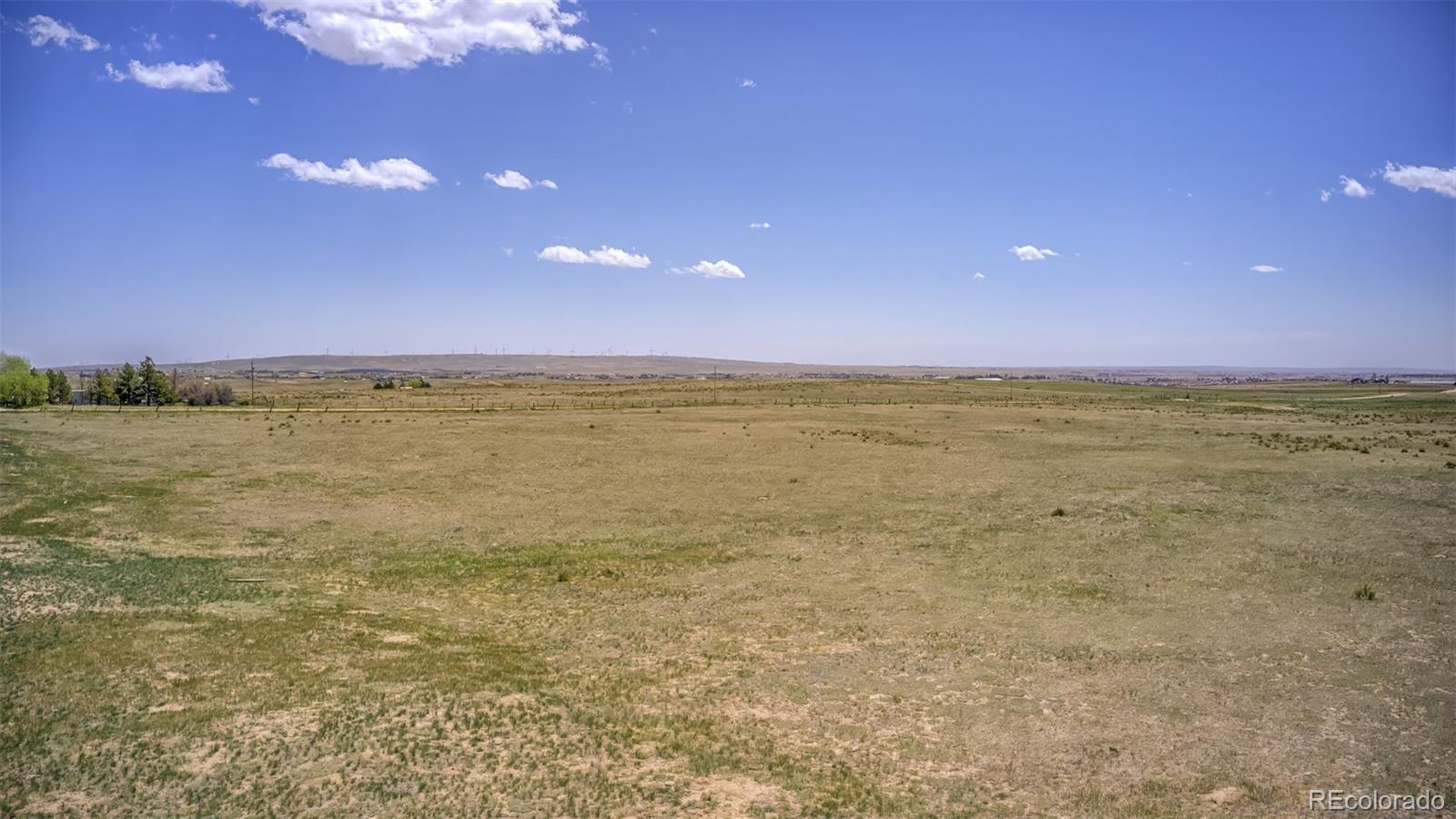 13886 Log Road Peyton, CO 80831 - Photo 14 of 14 a view of an ocean beach and a yard