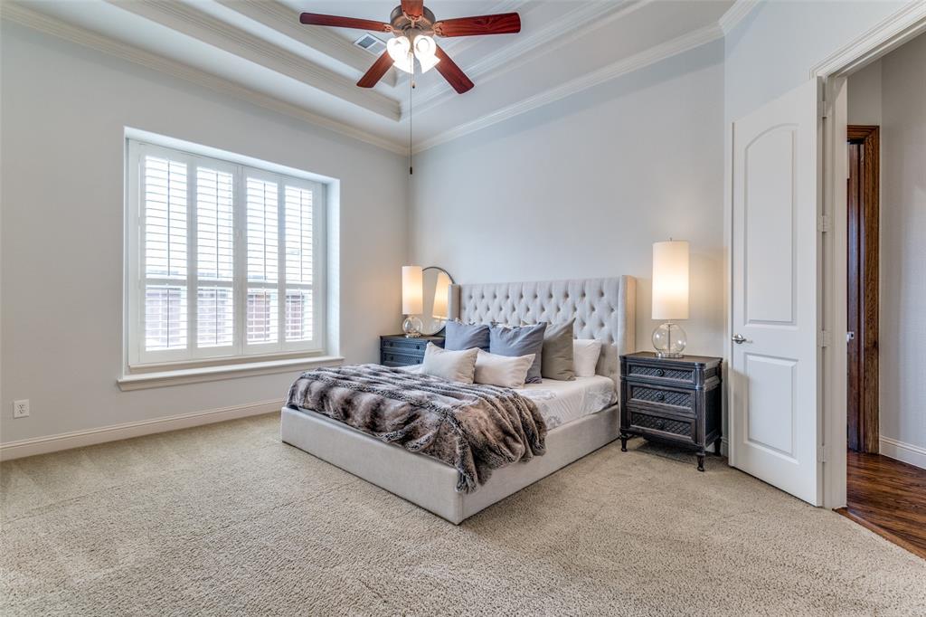 8237 Inverness The Colony, TX 75056 - Photo 11 of 22 a spacious bedroom with a bed and a chandelier