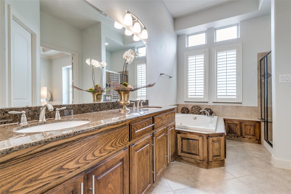 8237 Inverness The Colony, TX 75056 - Photo 12 of 22 a spacious bathroom with a granite countertop sink a large mirror and a bathtub