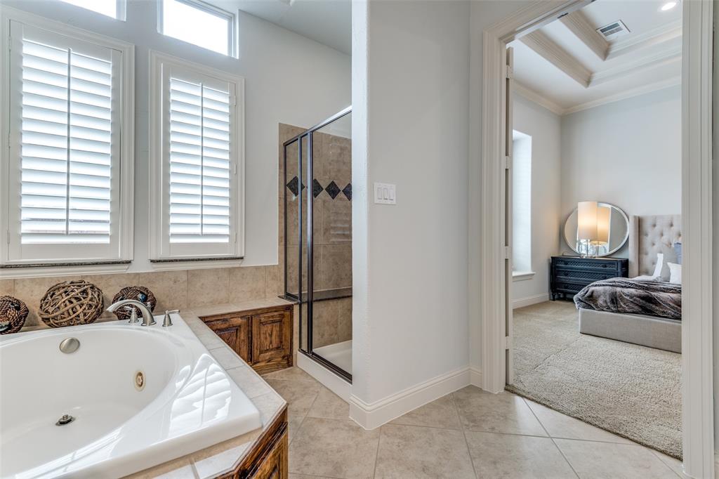 8237 Inverness The Colony, TX 75056 - Photo 13 of 22 a bath tub sitting in a bathroom next to a window