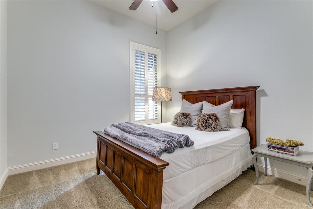 8237 Inverness The Colony, TX 75056 - Photo 14 of 22 a bedroom with a bed and a chandelier