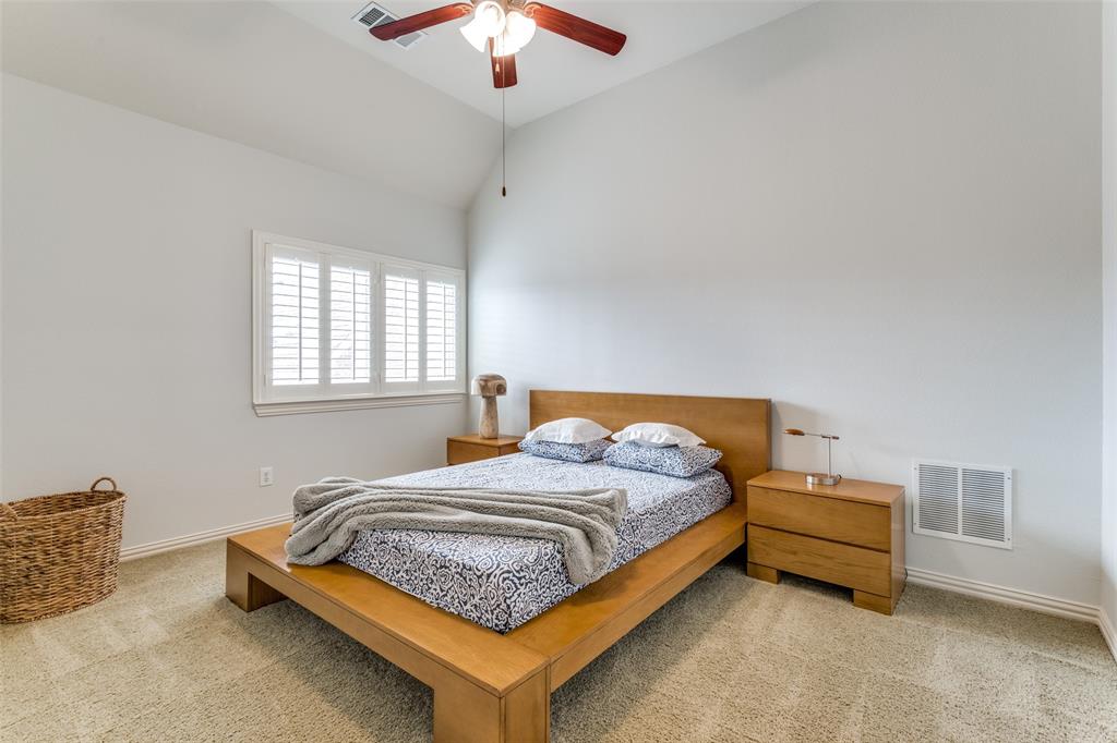 8237 Inverness The Colony, TX 75056 - Photo 18 of 22 a bedroom with a bed and a chandelier