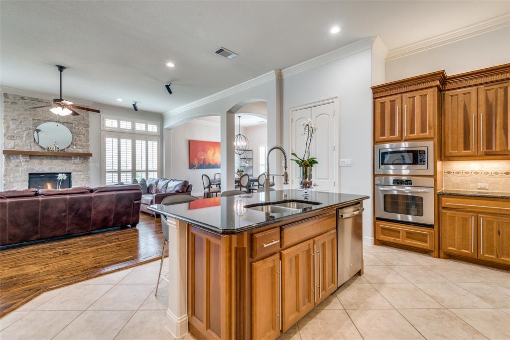 8237 Inverness The Colony, TX 75056 - Photo 8 of 22 a kitchen with stainless steel appliances a sink counter space cabinets and a large window