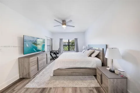 a bedroom with a bed and a potted plant