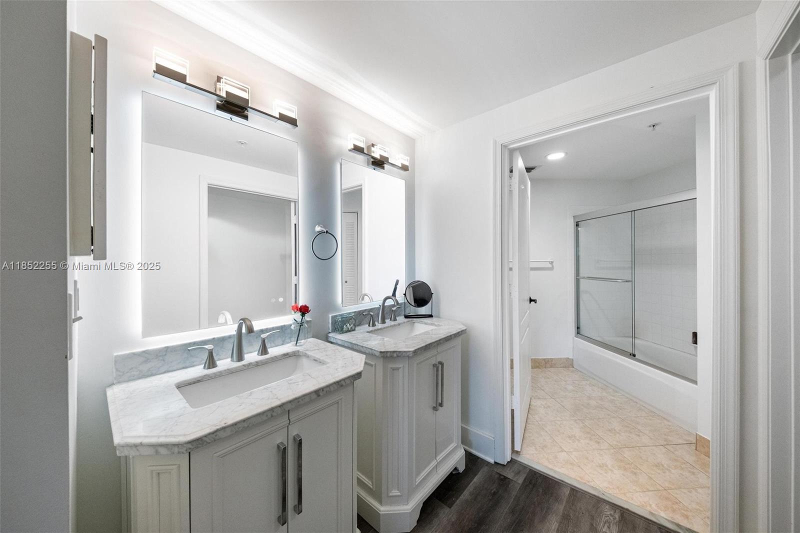 800 Uno Lago Drive, Unit 301 Juno Beach, FL 33408 - Photo 13 of 27 a bathroom with a sink double vanity and a mirror