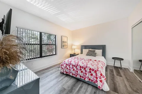 a bedroom with a bed and a night stand