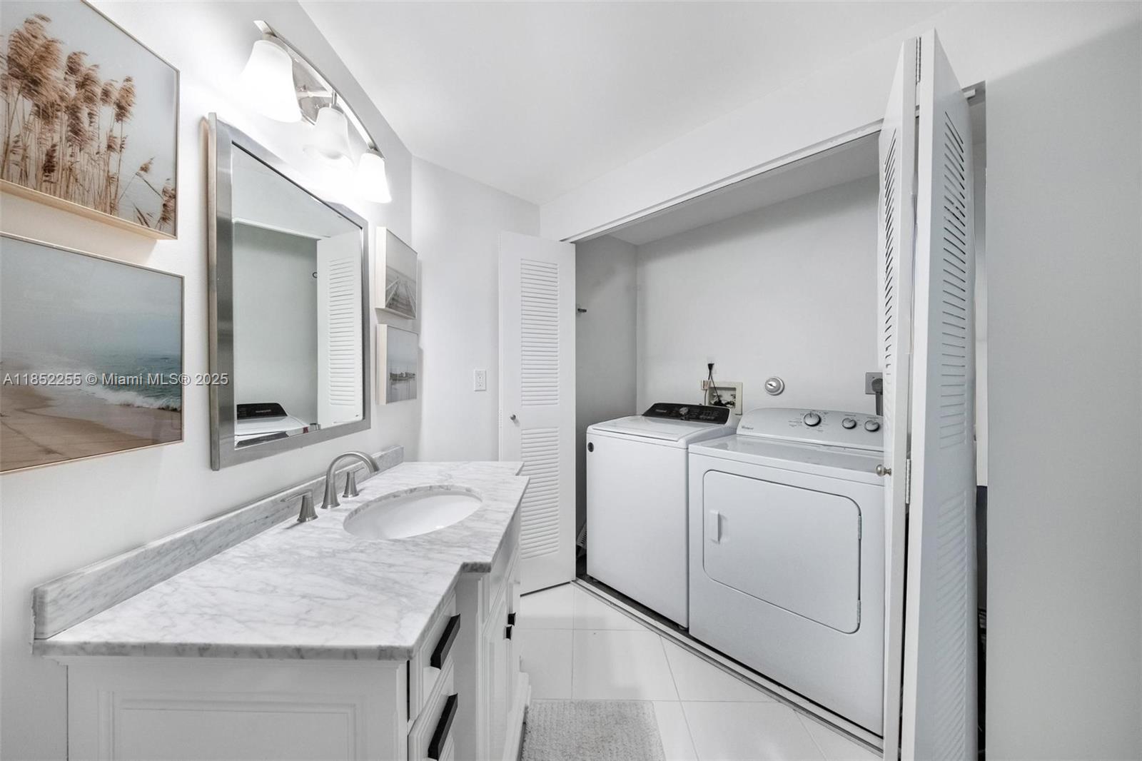 800 Uno Lago Drive, Unit 301 Juno Beach, FL 33408 - Photo 18 of 27 a bathroom with a sink and a mirror