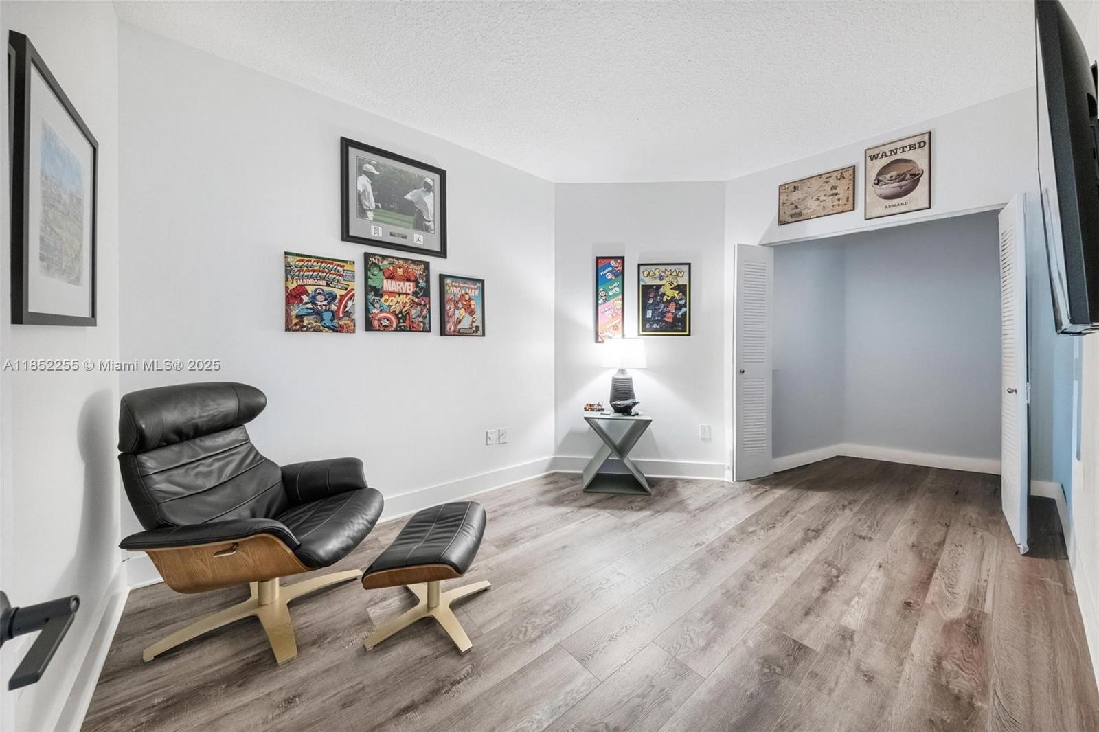 800 Uno Lago Drive, Unit 301 Juno Beach, FL 33408 - Photo 19 of 27 a workspace with wooden floor and a couch