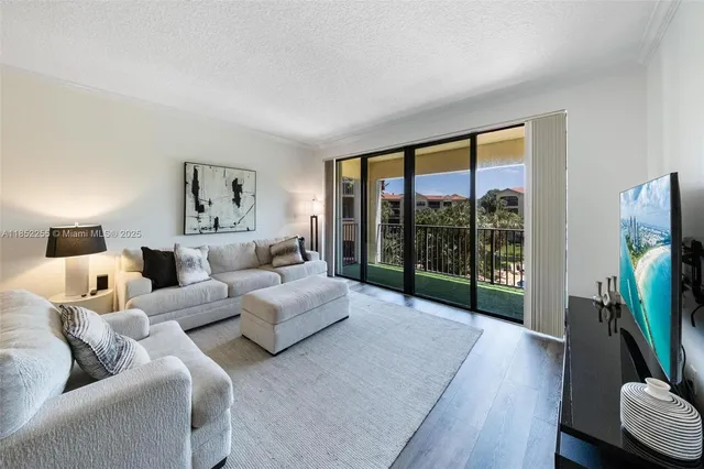 a living room with furniture large window and a flat screen tv