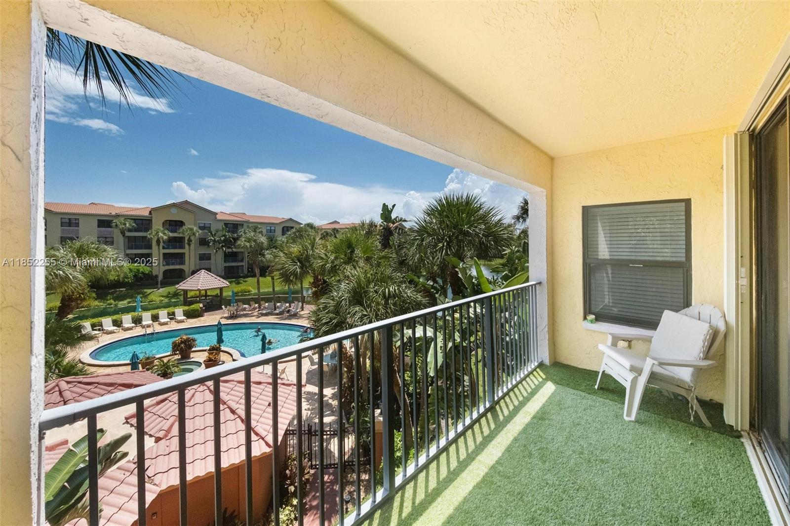 800 Uno Lago Drive, Unit 301 Juno Beach, FL 33408 - Photo 21 of 27 a view of a chair and tables in the balcony