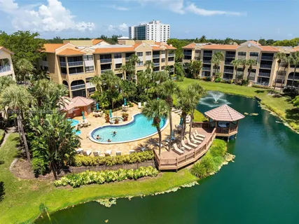 a swimming pool with outdoor seating and lots of trees