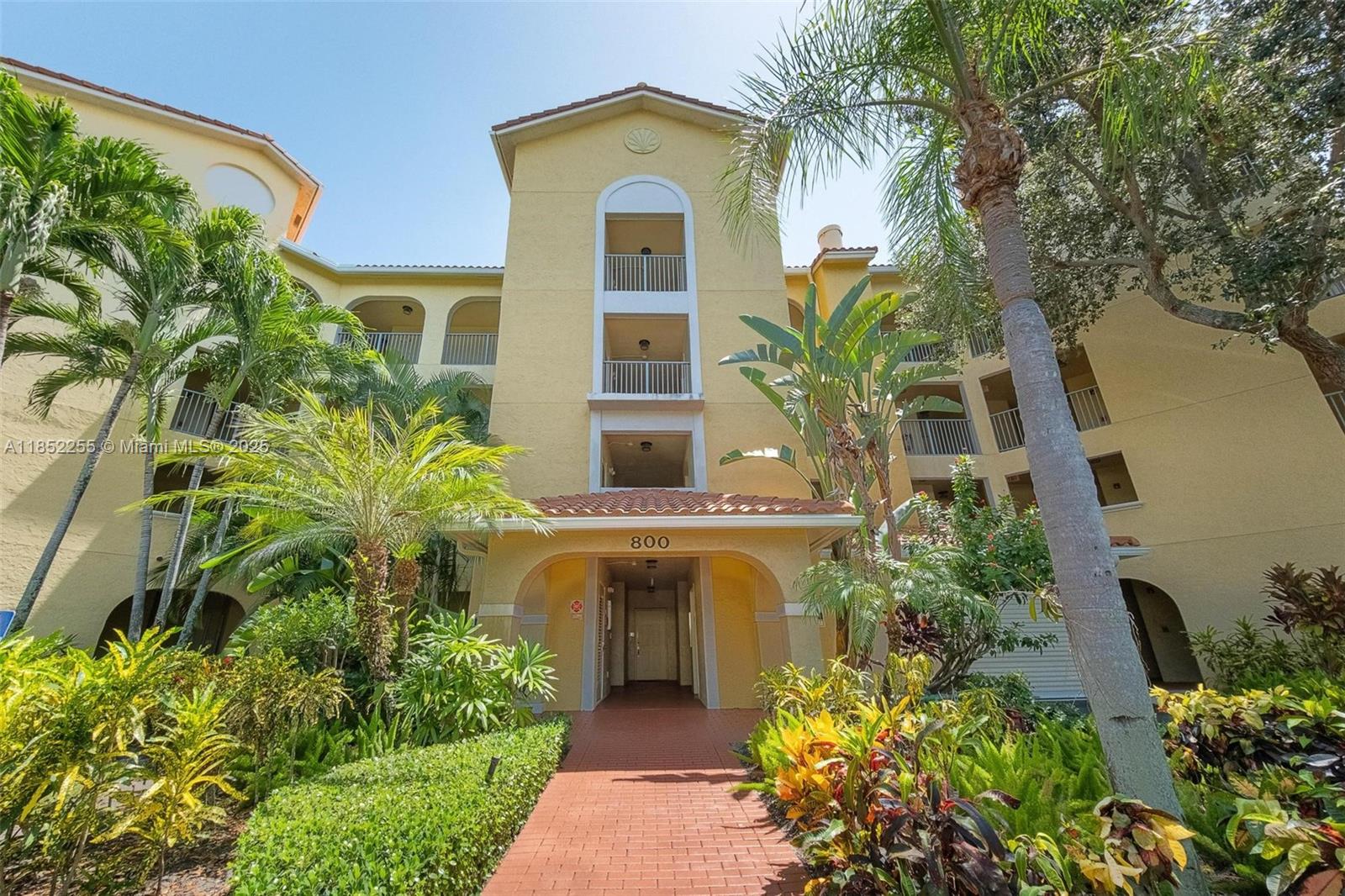 800 Uno Lago Drive, Unit 301 Juno Beach, FL 33408 - Photo 25 of 27 a front view of a house with a garden