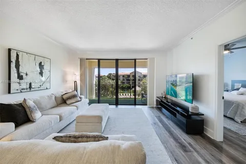 a living room with furniture large window and a flat screen tv