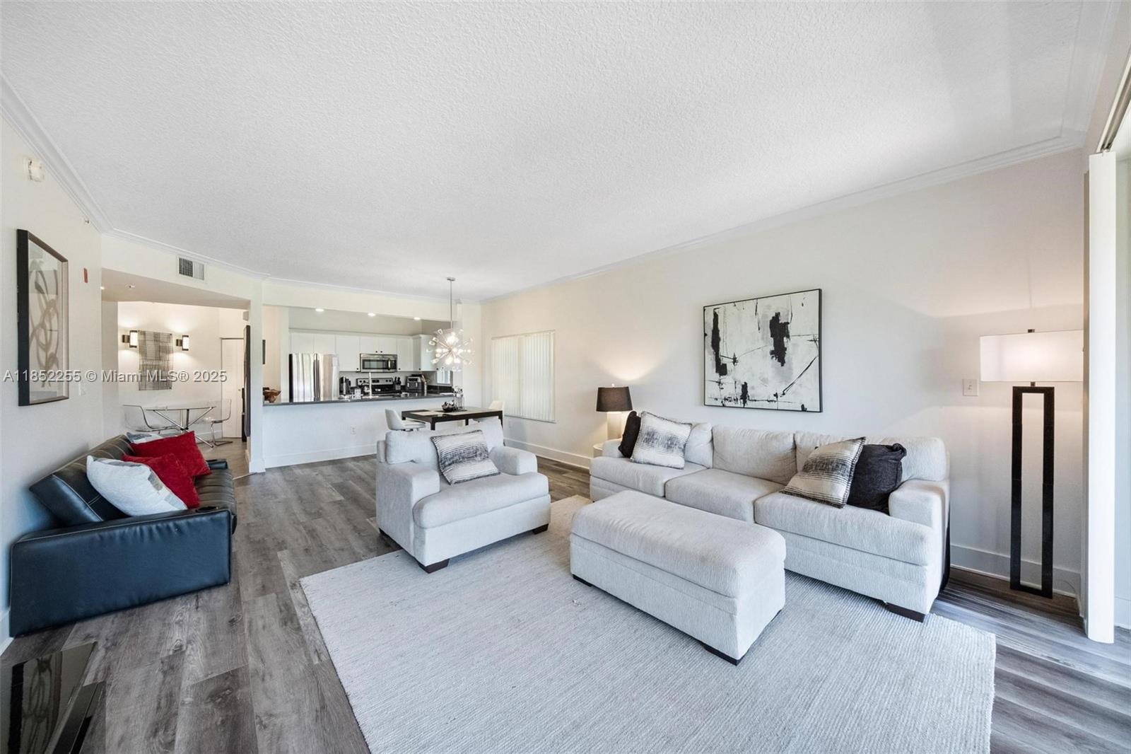 800 Uno Lago Drive, Unit 301 Juno Beach, FL 33408 - Photo 4 of 27 a living room with furniture and a couch