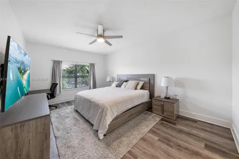 a bed room with furniture and a flat screen tv