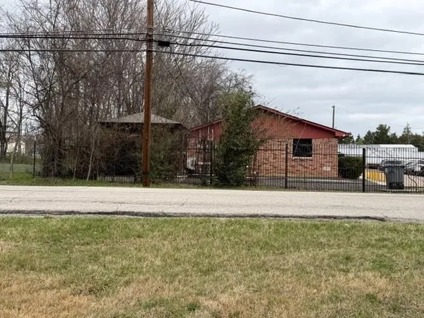 a view of a yard with wooden fence