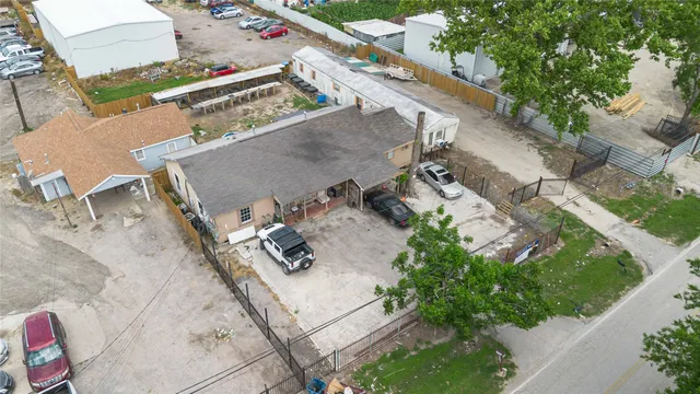 an aerial view of a house with a yard