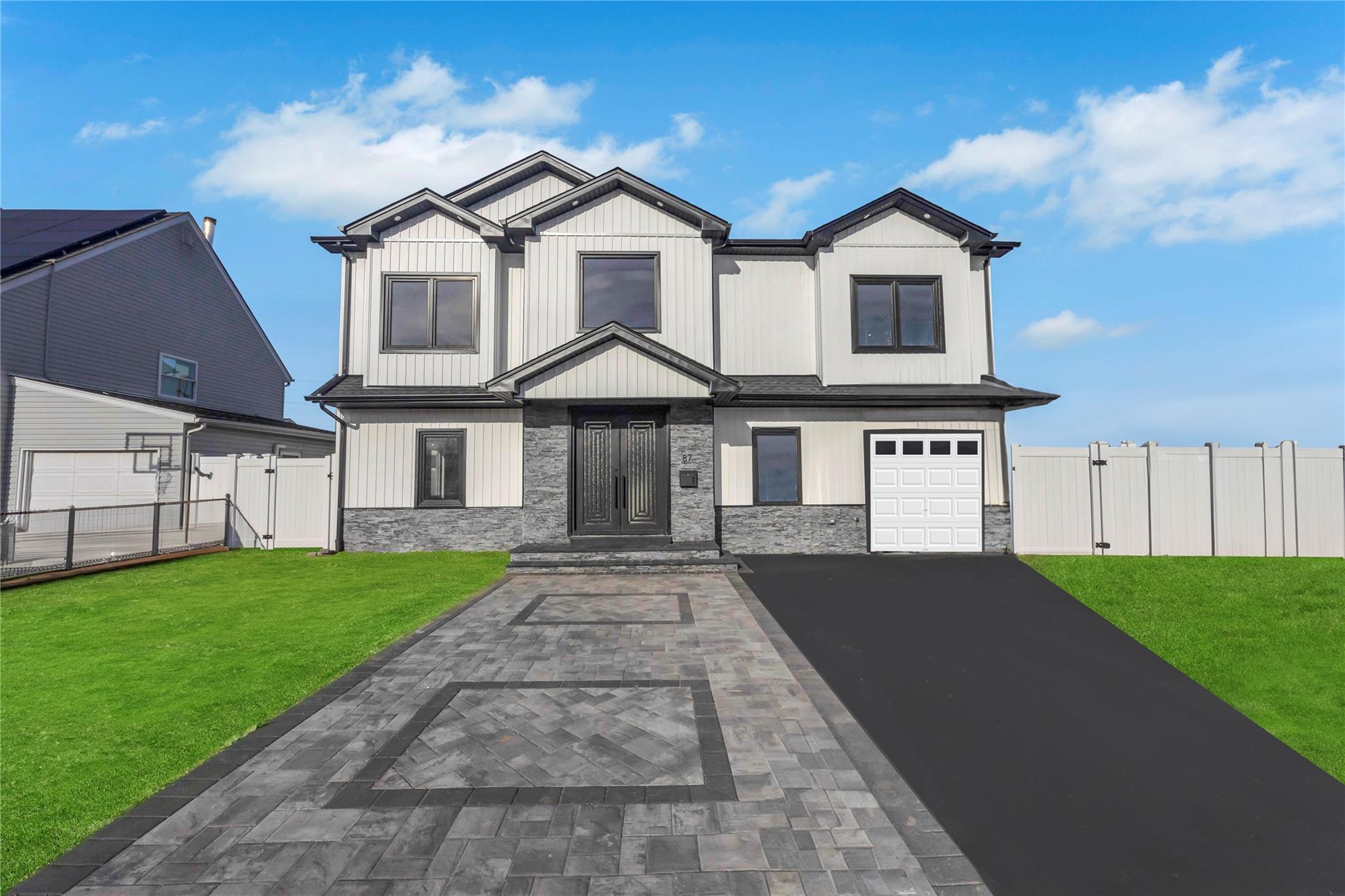 87 Sugar Maple Road Levittown, NY 11756 - Photo 1 of 1 View of front of property with a front yard and a garage