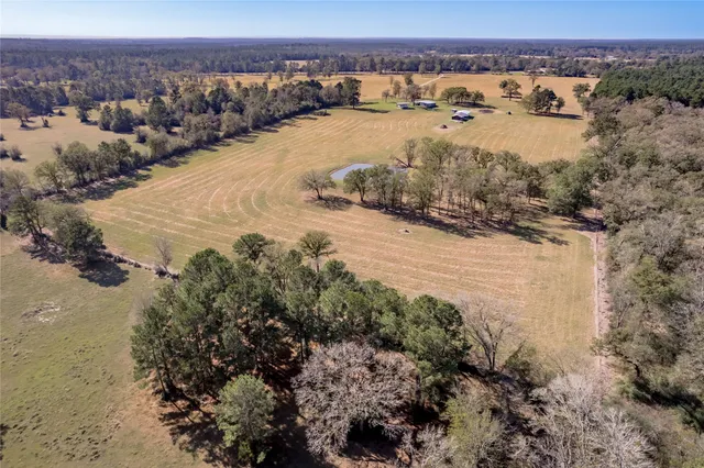 a view of a lake in middle of a field