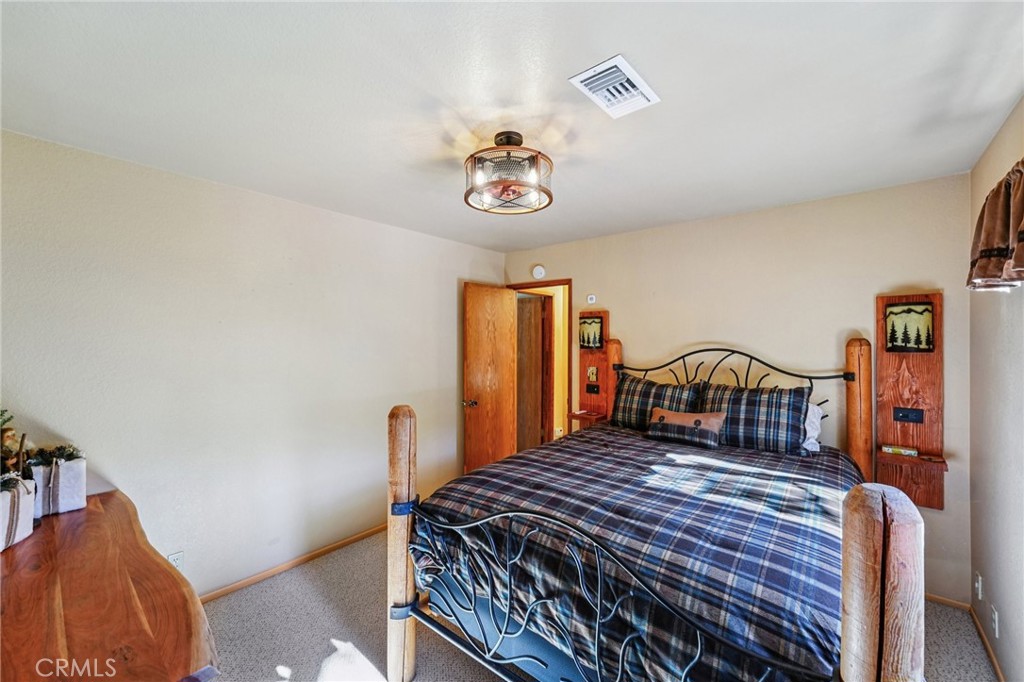 1847 Thrush Road Wrightwood, CA 92397 - Photo 9 of 33 a bedroom with a bed and wooden floor
