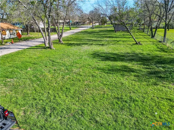 a view of grassy field with benches