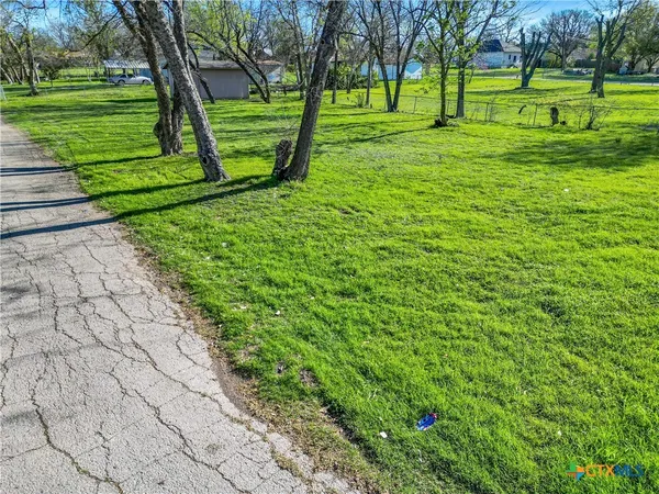 a view of a backyard with wooden fence