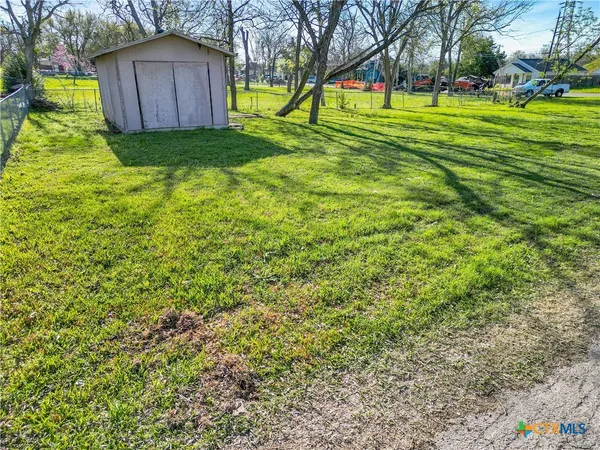 a view of a backyard with large trees