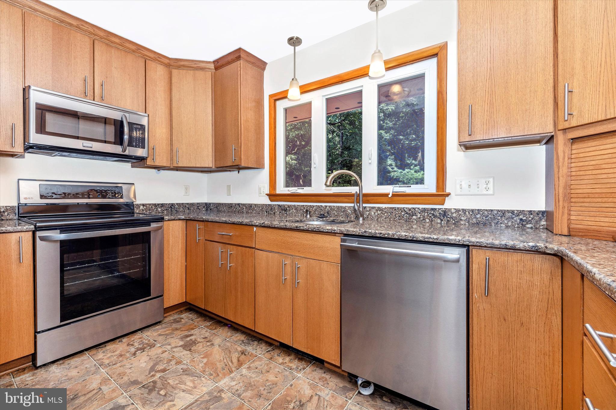 8911 Yellow Springs Road Frederick, MD 21702 - Photo 12 of 37 a kitchen with stainless steel appliances granite countertop a stove a sink and a microwave