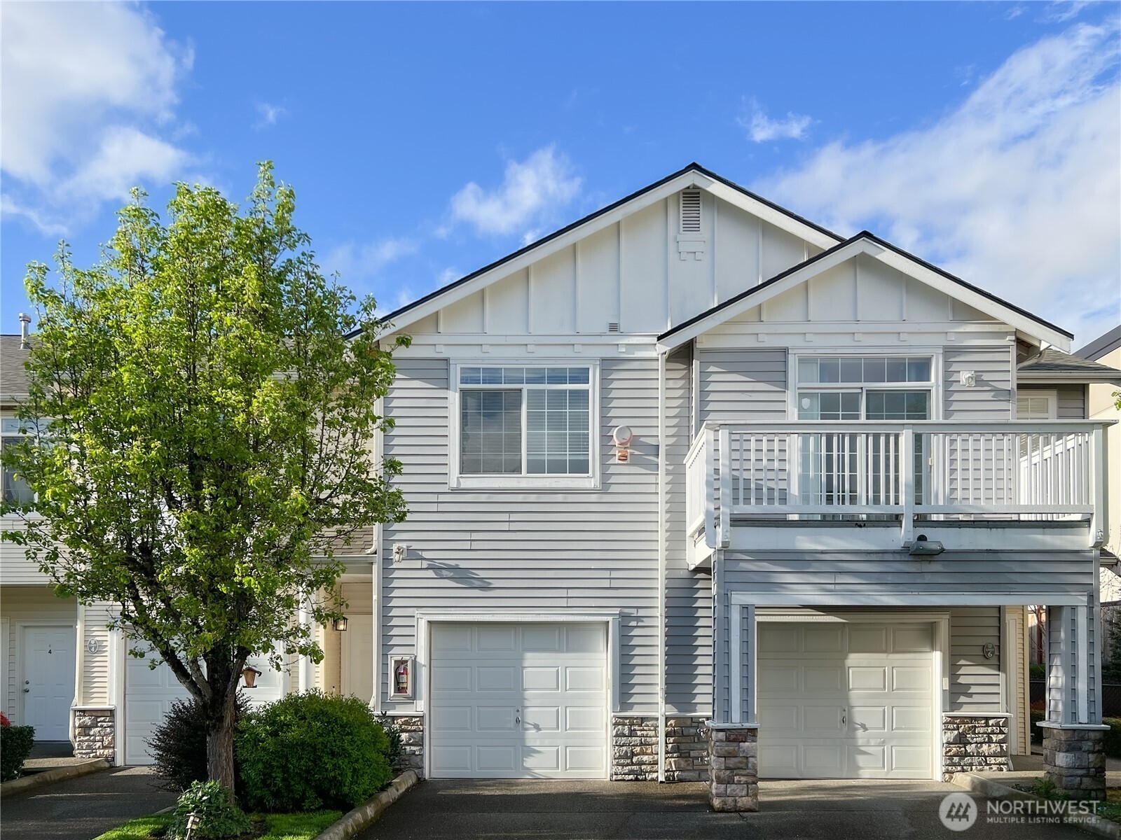 6832 20th Street East, Unit 5 Fife, WA 98424 - Photo 1 of 18 a front view of a house with garage