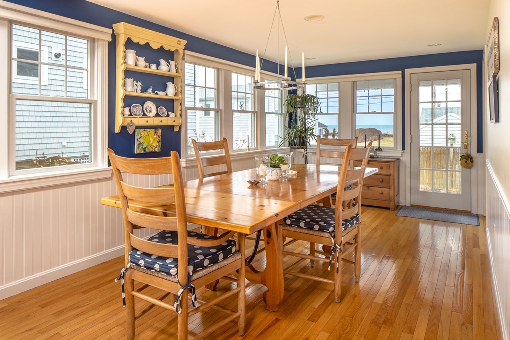 7 Mattakiset Road Mattapoisett, MA 02739 - Photo 13 of 39 a dining room with wooden floor and large windows