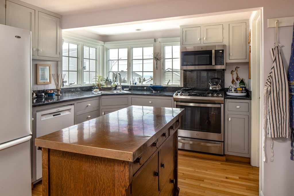 7 Mattakiset Road Mattapoisett, MA 02739 - Photo 20 of 39 a kitchen with kitchen island granite countertop a stove a sink and a refrigerator