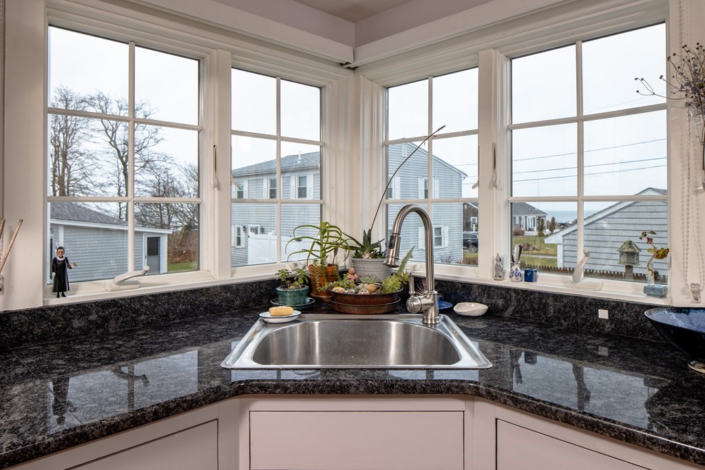 7 Mattakiset Road Mattapoisett, MA 02739 - Photo 21 of 39 a kitchen with a sink a counter and a large window