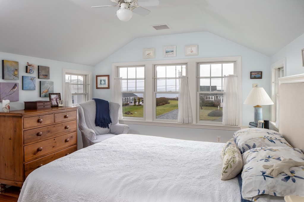 7 Mattakiset Road Mattapoisett, MA 02739 - Photo 25 of 39 a bedroom with a bed and large windows