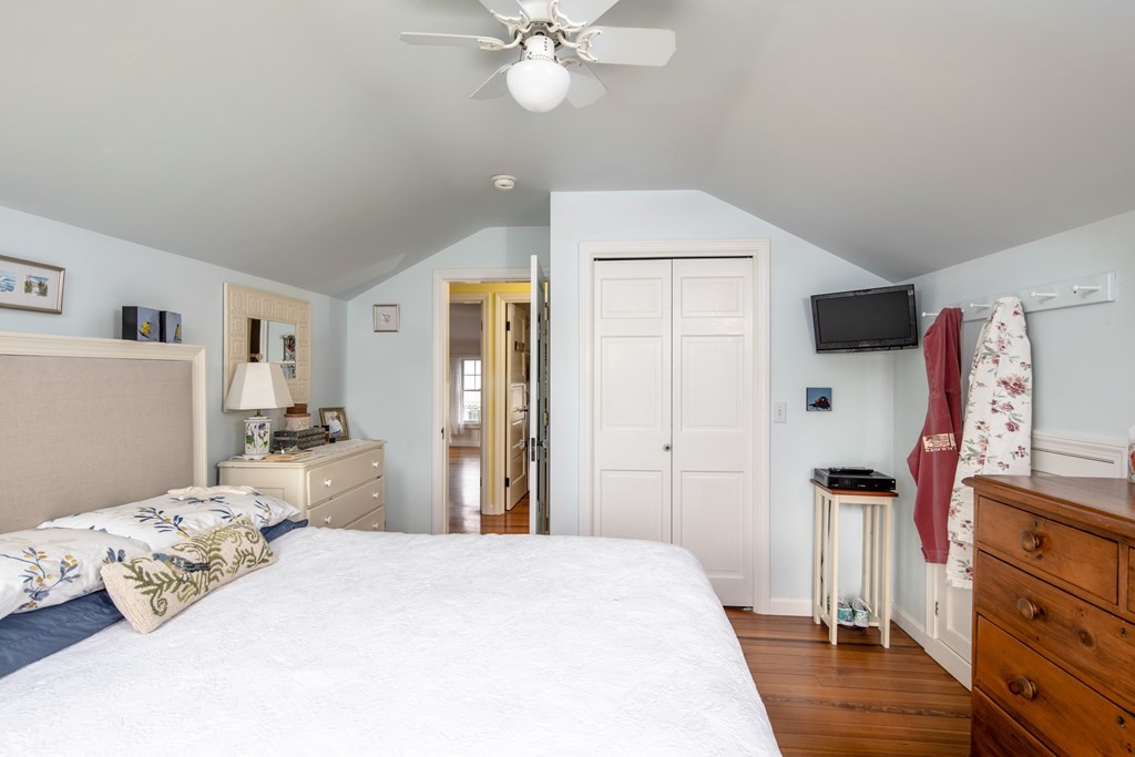 7 Mattakiset Road Mattapoisett, MA 02739 - Photo 26 of 39 a bedroom with a bed and a flat tv screen on dresser