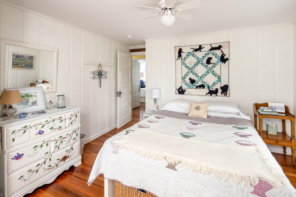 7 Mattakiset Road Mattapoisett, MA 02739 - Photo 32 of 39 a bedroom with a bed a dresser and painting on the wall