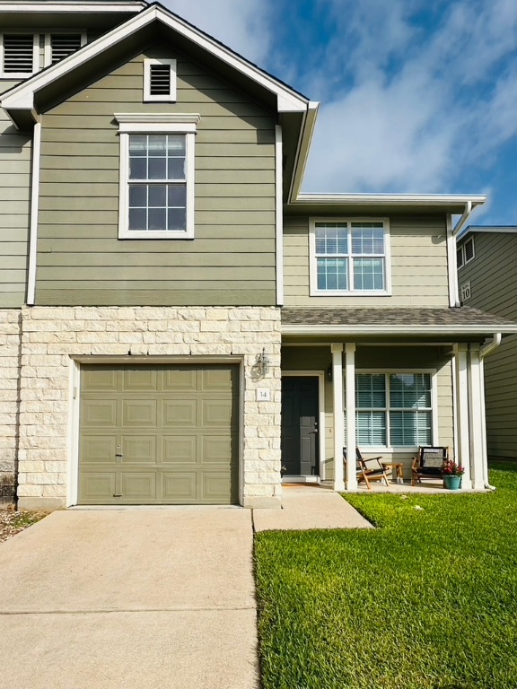 2632 Century Park Boulevard, Unit 34 Austin, TX 78727 - Photo 3 of 16 a front view of a house with a yard and garage