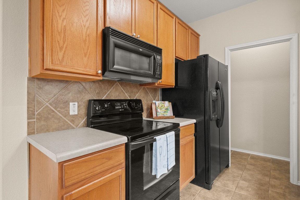 2632 Century Park Boulevard, Unit 34 Austin, TX 78727 - Photo 8 of 16 a kitchen with stainless steel appliances granite countertop a refrigerator stove and microwave