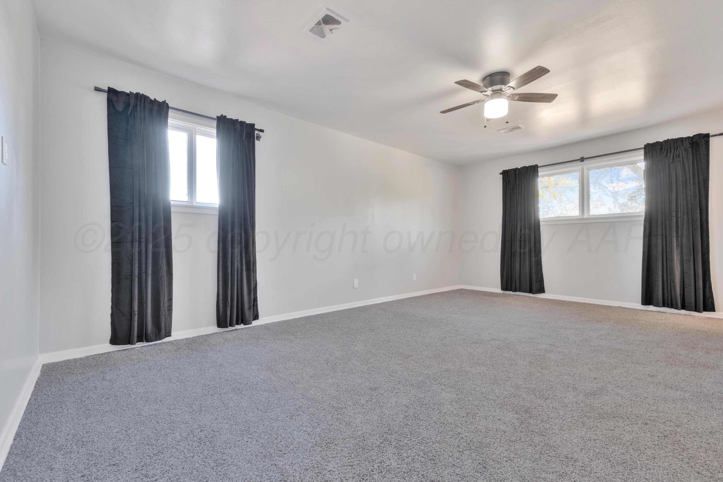 3700 Paramount Boulevard Amarillo, TX 79109 - Photo 24 of 43 a view of a hallway with closet and a chandelier fan