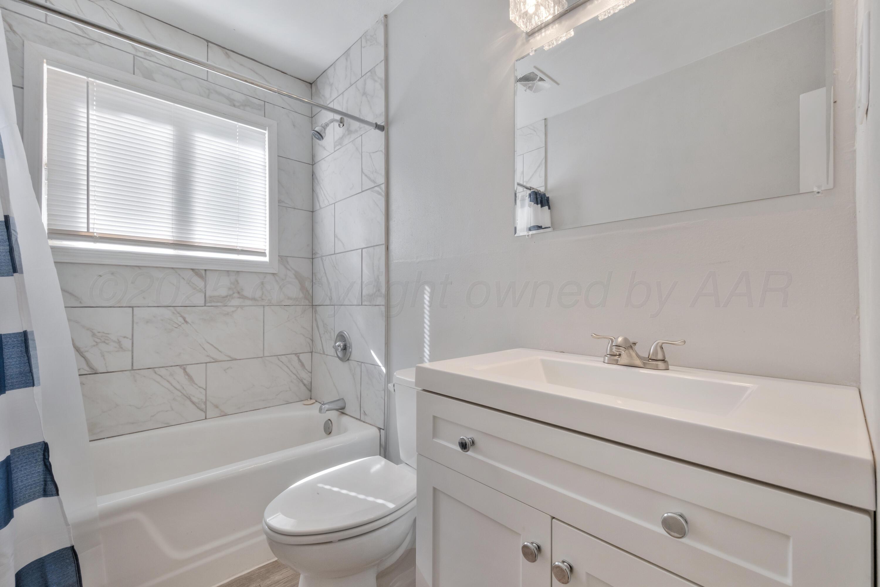 3700 Paramount Boulevard Amarillo, TX 79109 - Photo 31 of 43 a bathroom with a sink a toilet and shower
