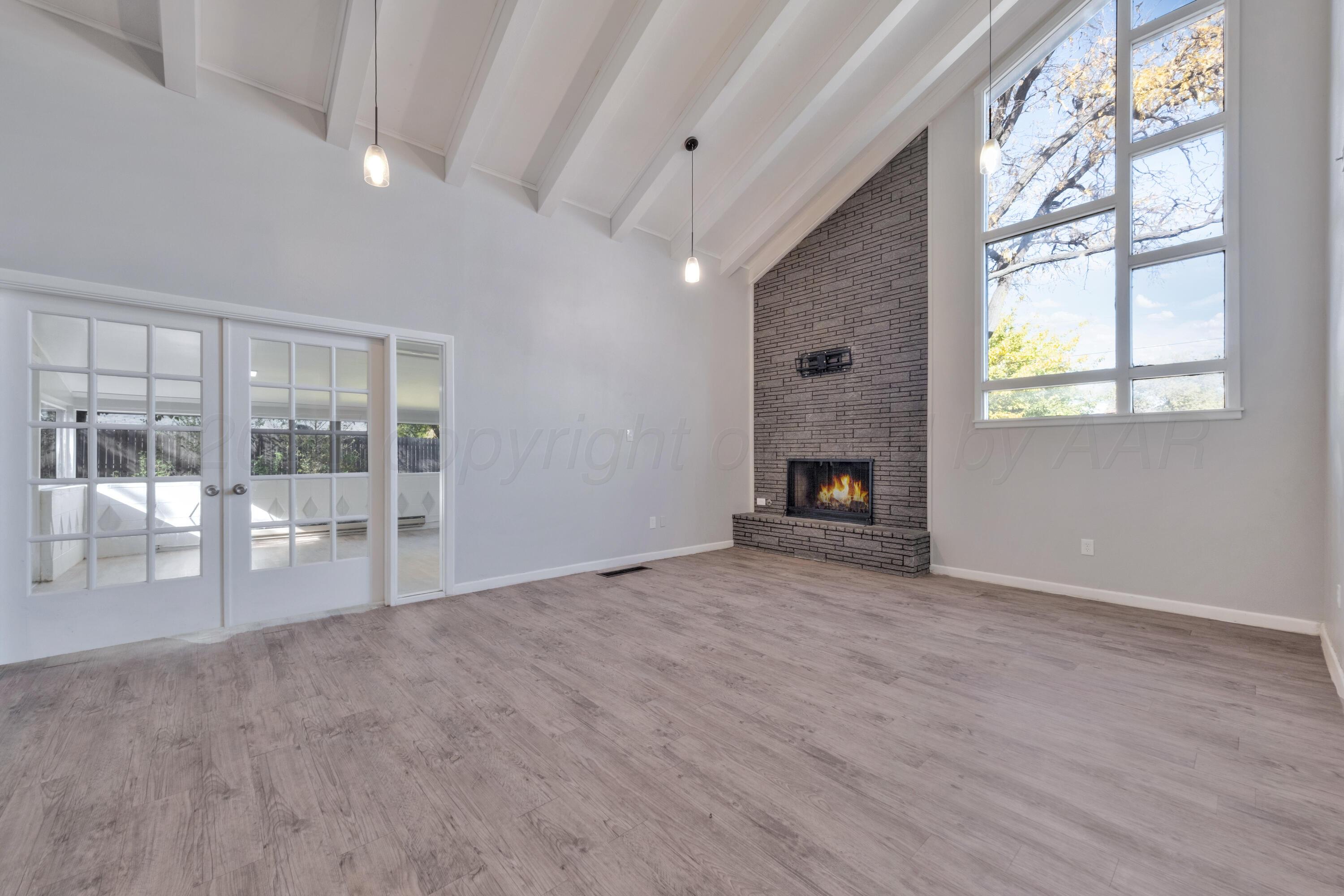3700 Paramount Boulevard Amarillo, TX 79109 - Photo 6 of 43 a view of an empty room with a fireplace and a window