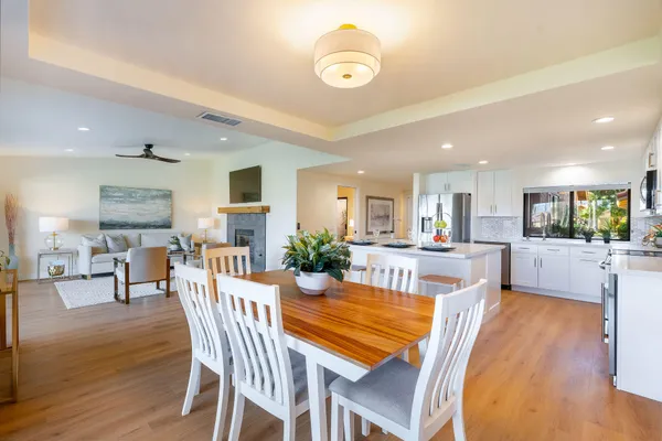 a view of a dining room with furniture and wooden floor