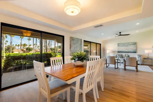a view of a dining room with furniture window and wooden floor