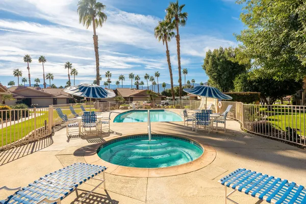 a view of a swimming pool with a lounge chairs