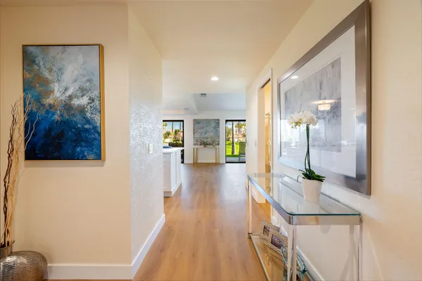 a view of a hallway view with wooden floor and staircase
