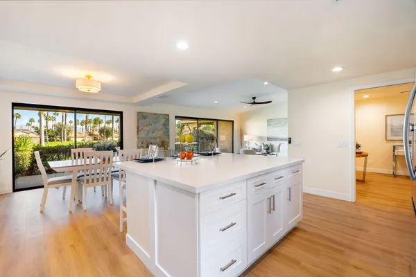 a view of a kitchen with kitchen island wooden floor and living room